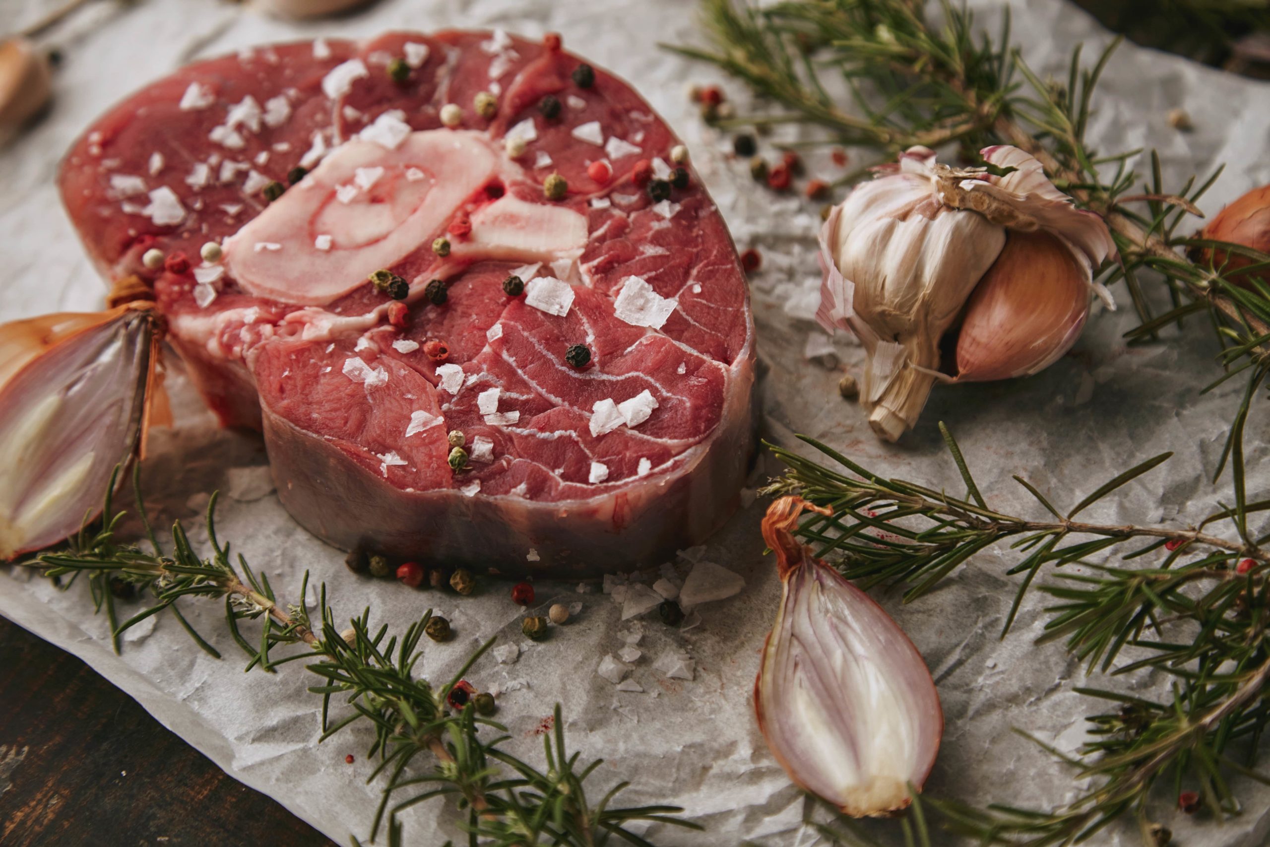 food-set-onions-romero-raw-meat-steak-salt-pepper-garlic-olive-oil-fork-closeup-min