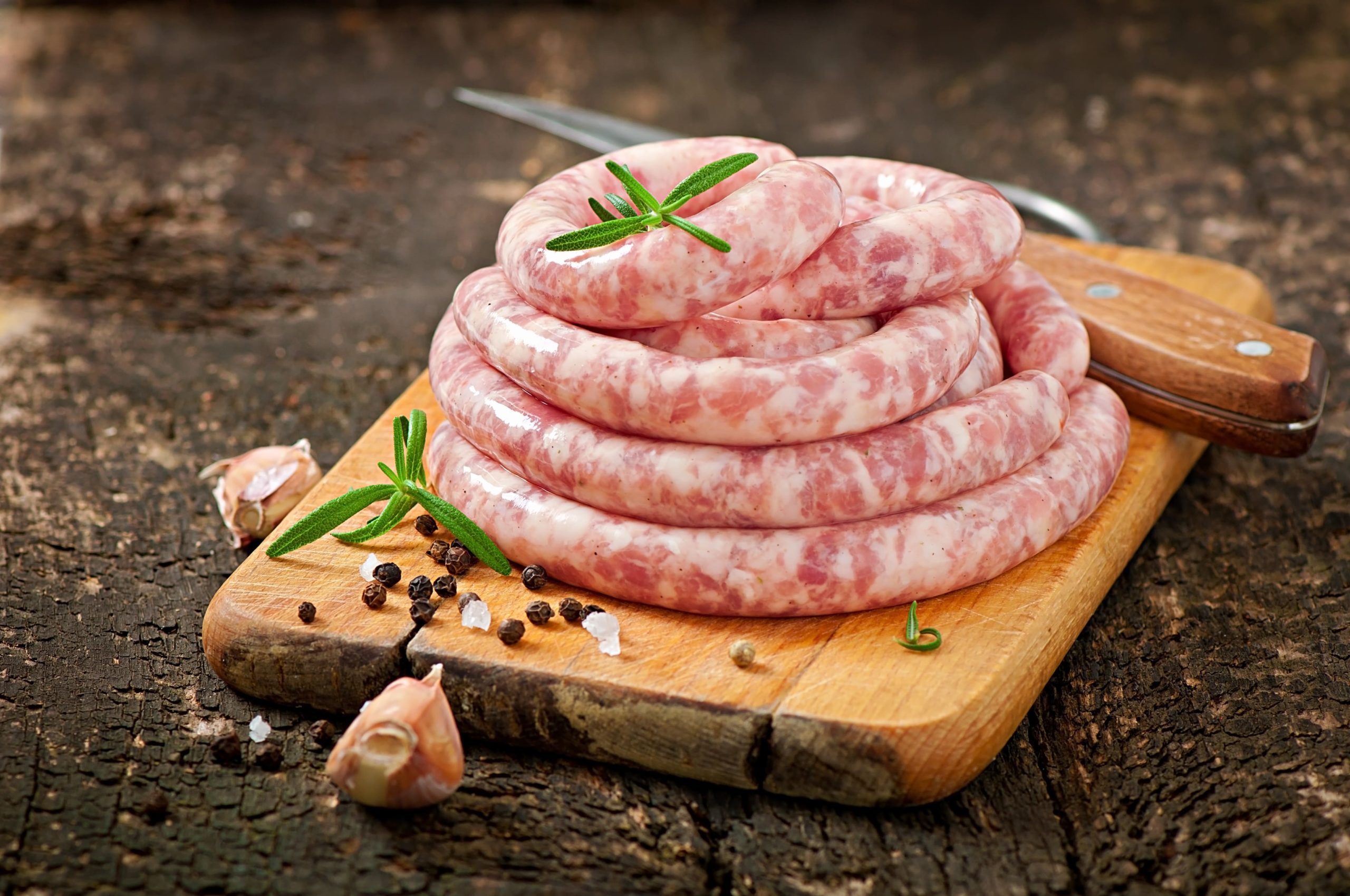 fresh-raw-sausage-on-the-old-wooden-min